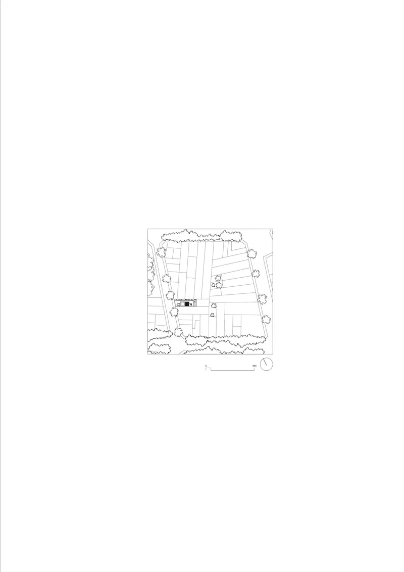 Site plan drawing showing a rectangular structure surrounded by trees and paved surfaces