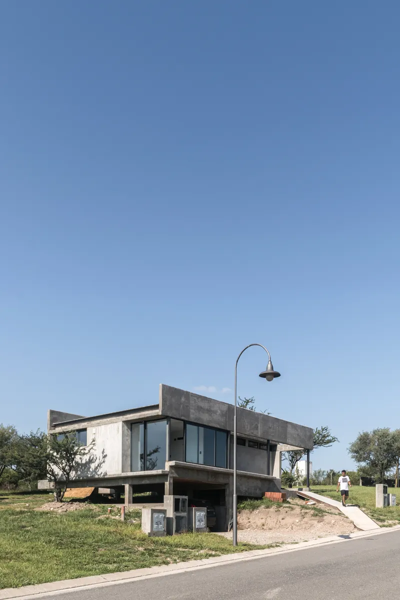 Street view of the raised concrete structure with curved street lamp and walking figure