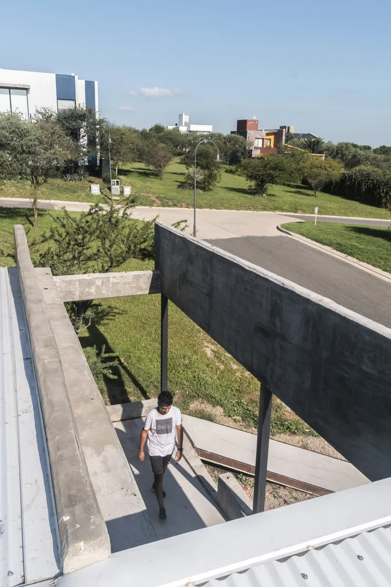 Overhead view of concrete entry bridge connecting the dwelling to the neighborhood street