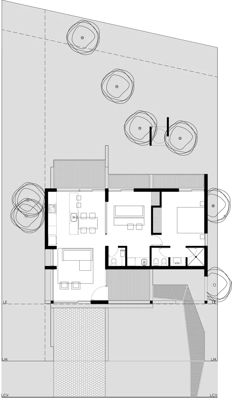 Floor plan drawing showing an open-plan living area, bedroom, and bathrooms with outdoor terraces