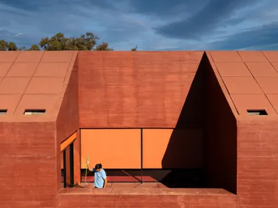 Spaceworkers Anchors a Red Concrete Museum to the Algarve Cliffs at Vila do Bispo