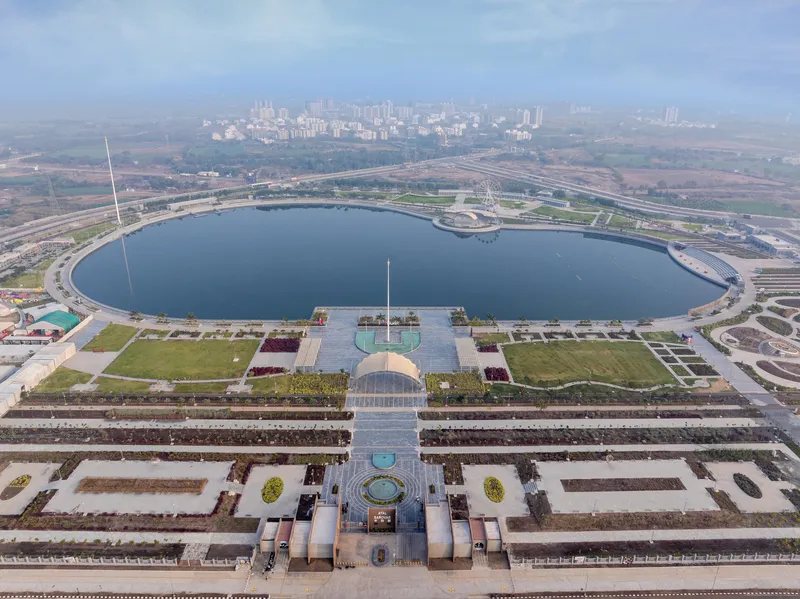 Drone view of the terraced entry plaza leading to the circular water body beyond