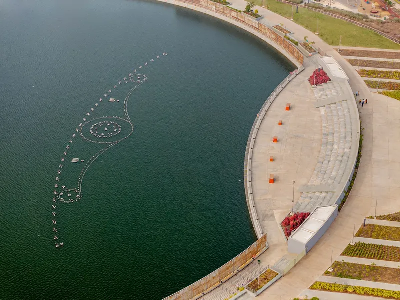 Overhead view of the curved amphitheater seating adjacent to the water with floating light installation