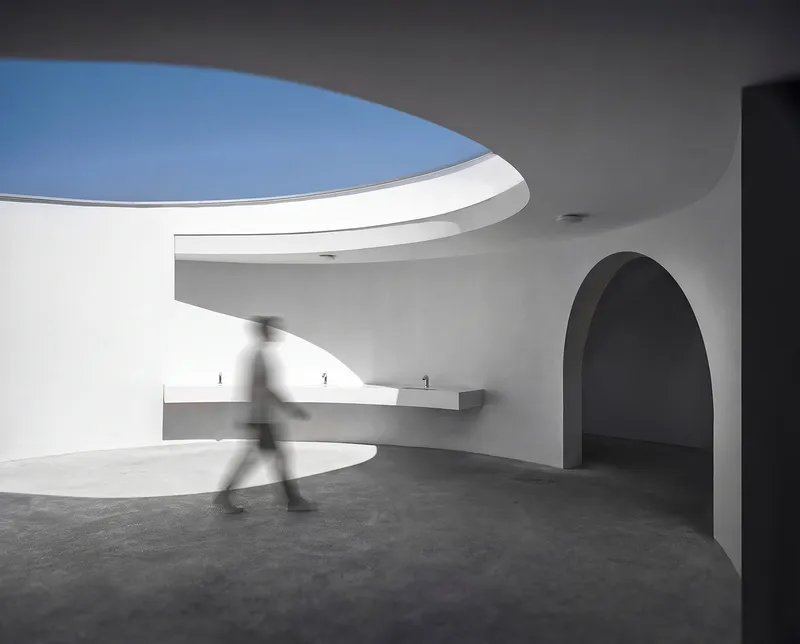 Interior view of the circular oculus above spiral counter with figure in motion blur