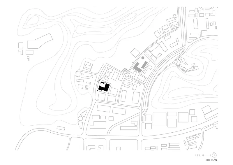 Site plan drawing showing building footprints with contour lines across the surrounding topography