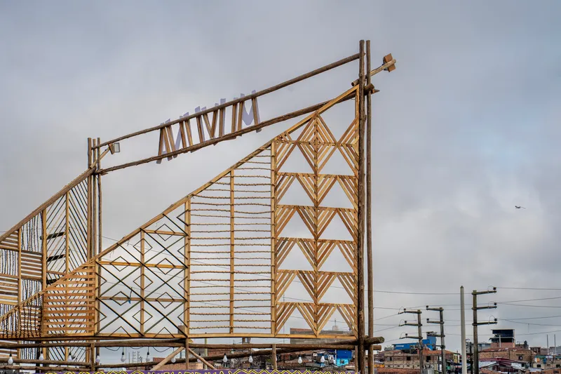 Bamboo frame walls with diagonal lattice patterns and horizontal slat infill under overcast sky