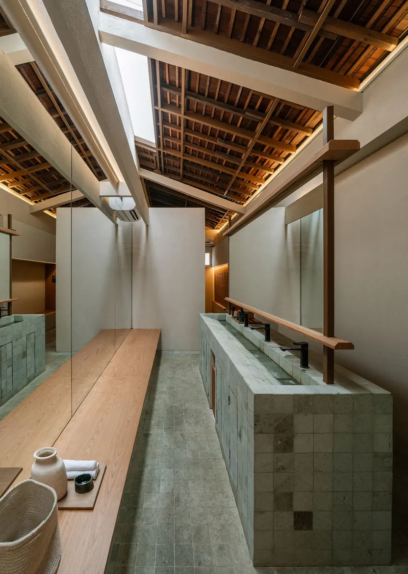 Interior view of exposed timber ceiling joists over tiled counters and skylights above