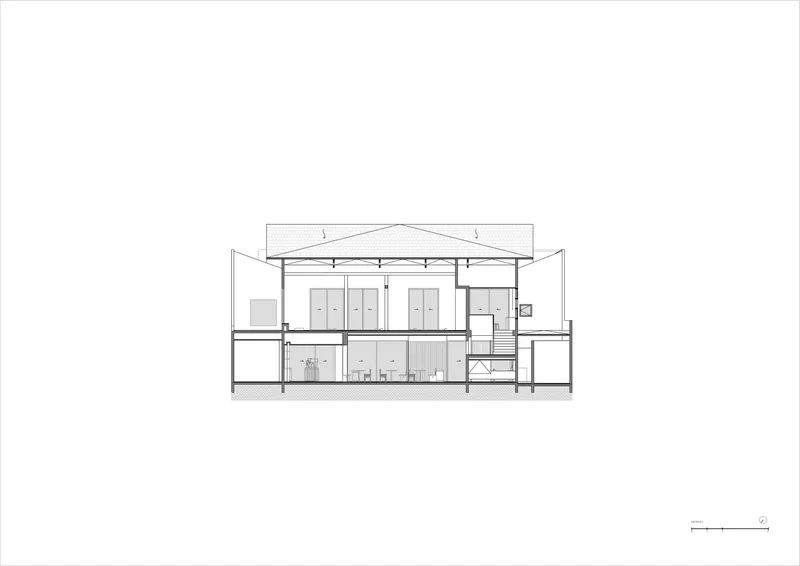 Section drawing revealing a two-story volume with exposed ceiling structure and interior partitions