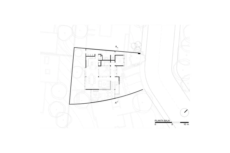 Ground floor plan drawing showing central courtyard with curved site boundary and surrounding landscape