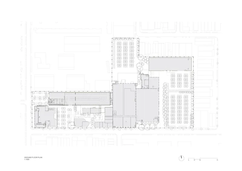 Ground floor plan drawing showing L-shaped layout with open spaces and adjacent parking areas