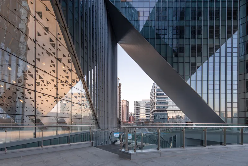 Plaza terrace beneath the triangular void with escalators descending to lower level