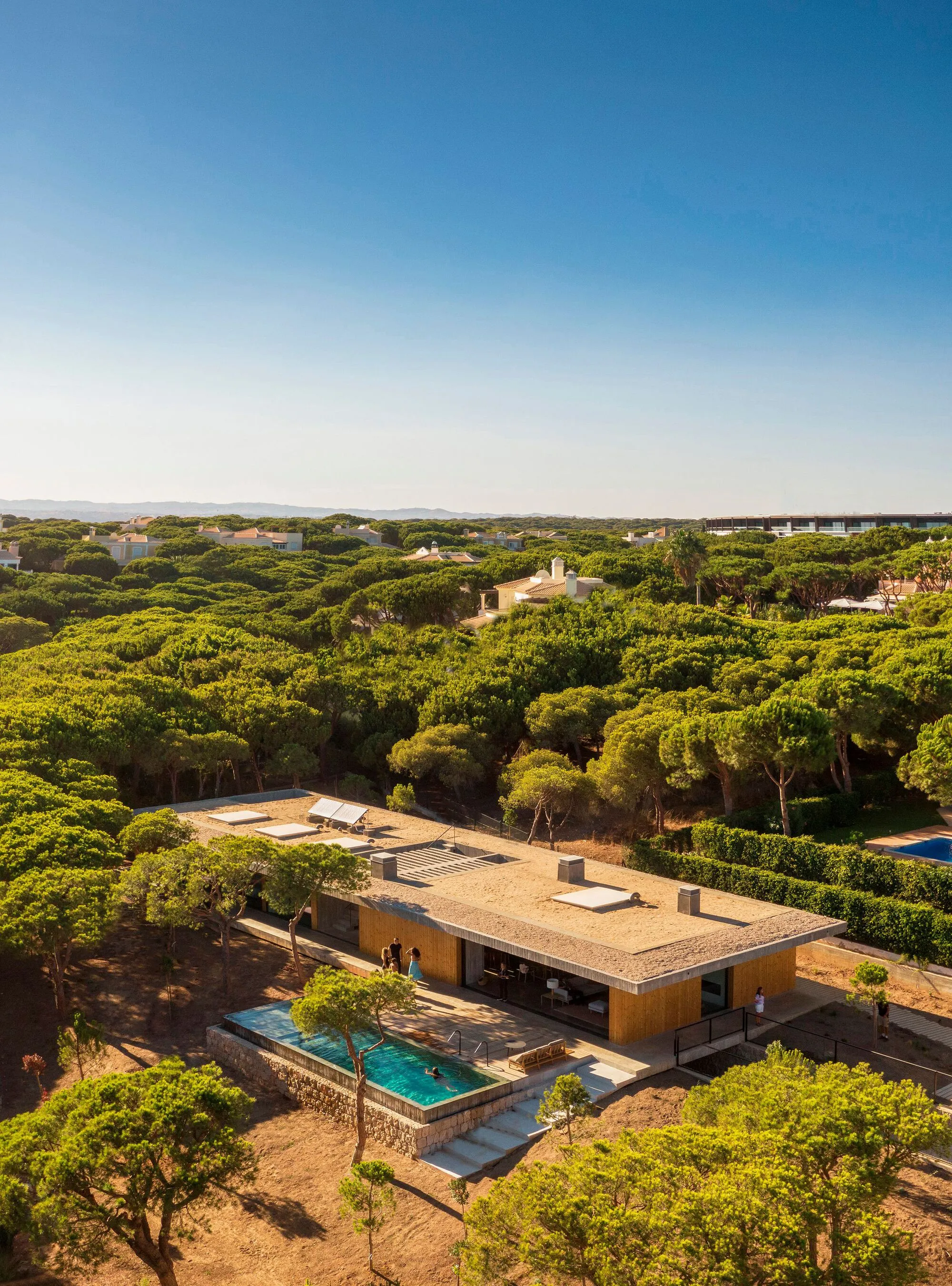 Atelier Central Arquitectos Slides a Concrete House Beneath the Pines of Southern Portugal