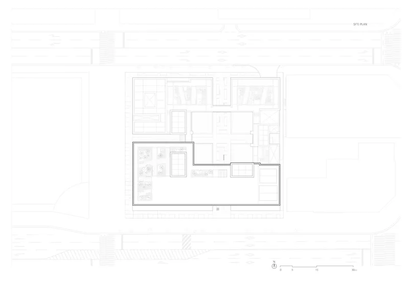 Site plan drawing showing the building footprint with a central courtyard and surrounding street context
