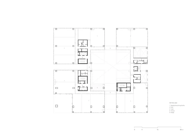 Floor plan drawing showing residential units arranged around open courtyards with structural grid