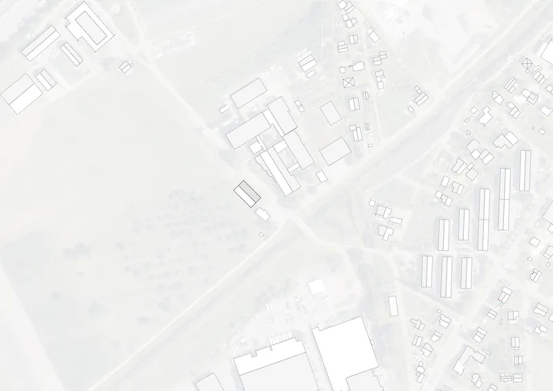 Site plan drawing showing building footprint among surrounding structures and roadways in an urban context