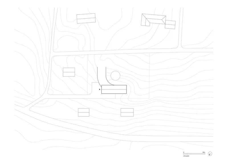 Site plan drawing with topographic contours showing building placement on sloping terrain