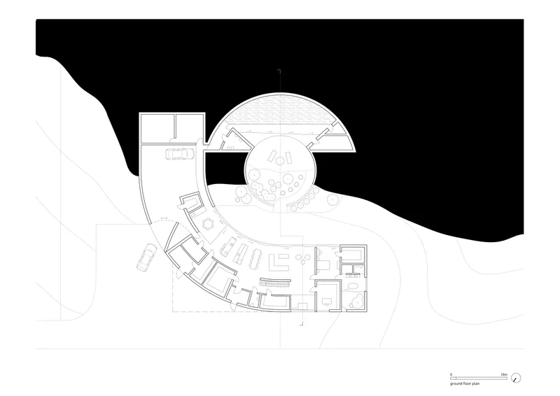Ground floor plan drawing showing an angular wing meeting a circular volume with radiating seating