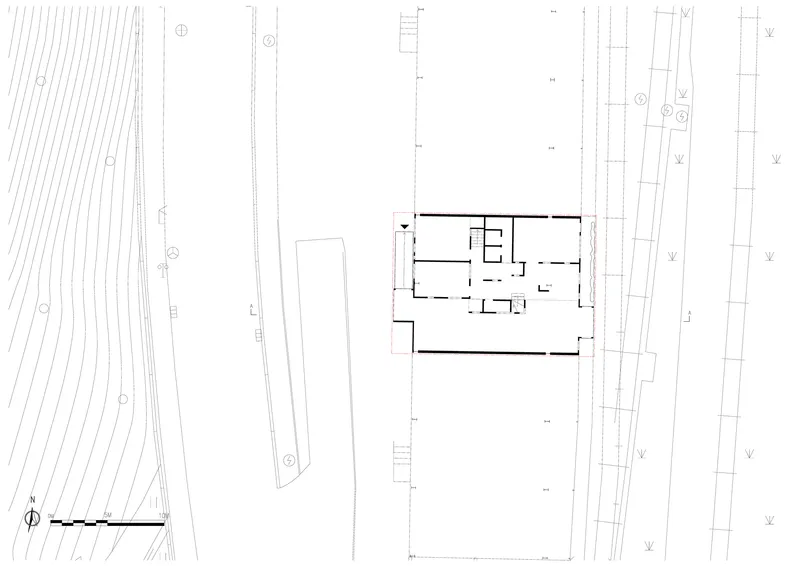 Site plan drawing showing the building footprint positioned between railway tracks and adjacent structures