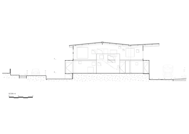 Section drawing showing the two-story interior layout with pitched roof and ground connection details