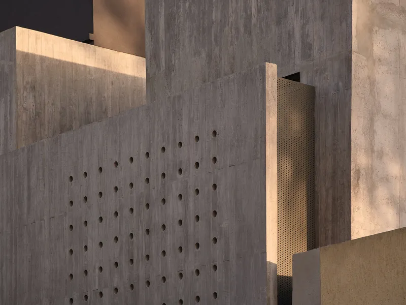 Board-formed concrete wall with dimpled tie holes illuminated by a recessed slot of warm light