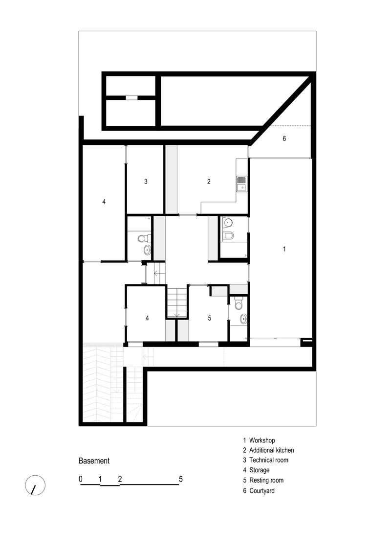 Basement floor plan showing workshop, kitchen, technical room, storage spaces and adjacent courtyard