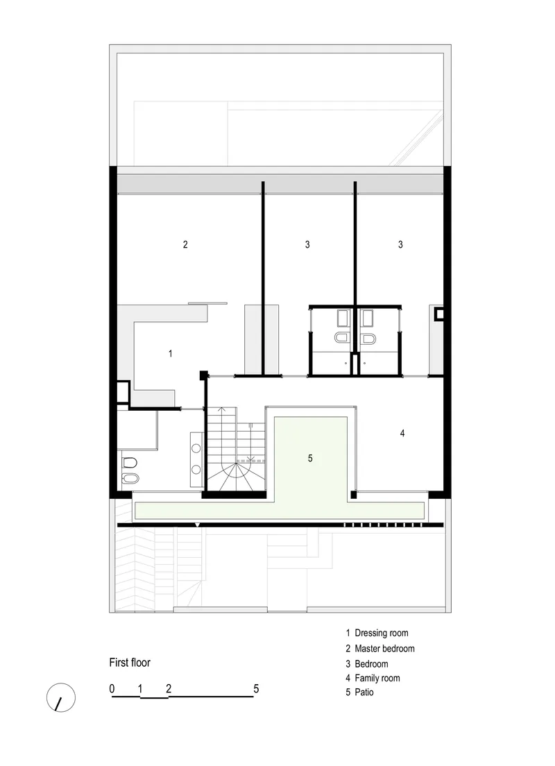 First floor plan drawing showing master bedroom, bedrooms, family room and patio around central stair