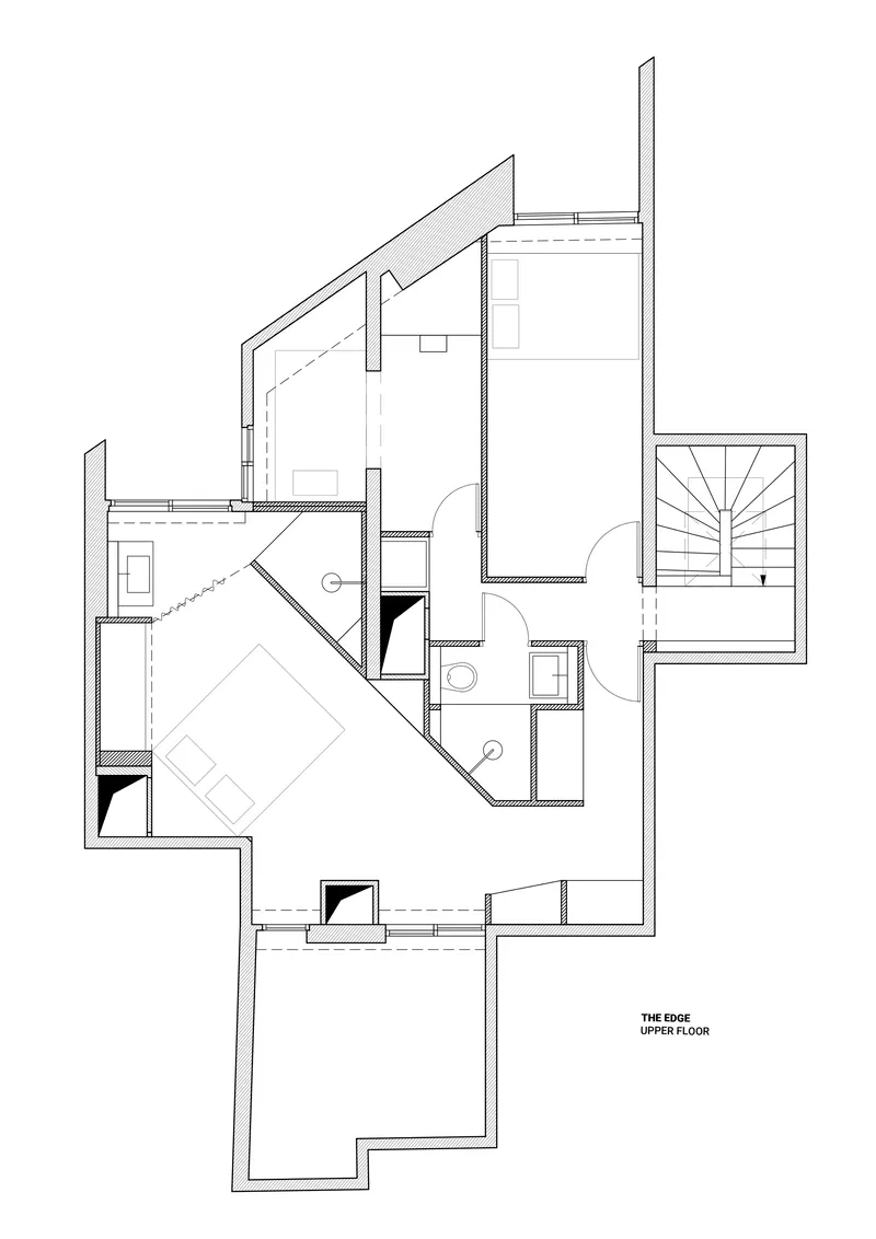Floor plan drawing showing upper level with bedroom, bathroom and sloped roof line