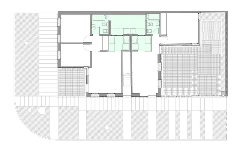 Floor plan showing two bathrooms flanking a central staircase with terraces and patterned surface areas