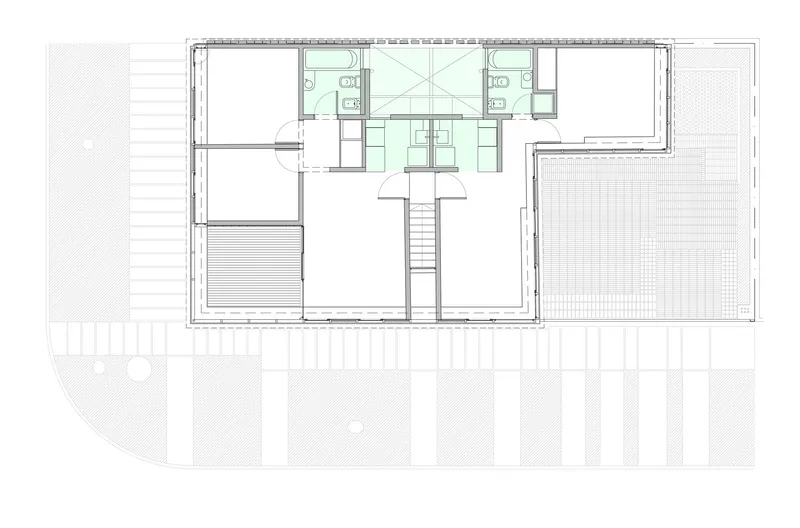 Floor plan showing upper level with central stairwell, two bathrooms, and surrounding enclosed spaces
