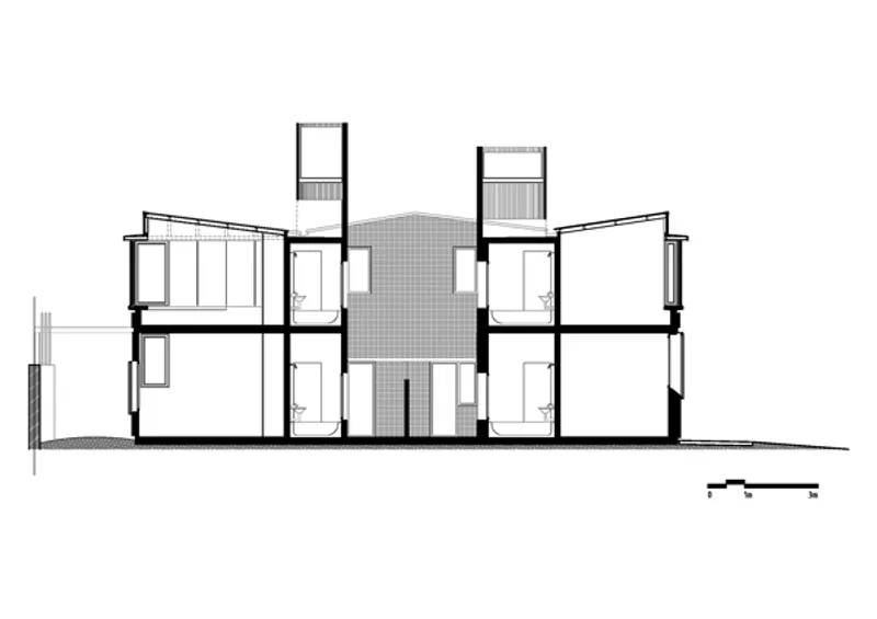 Section drawing showing symmetrical two-story volumes flanking a central atrium with vertical circulation
