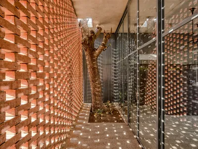 RA Design Studio Wraps a 60-Meter Brick Screen Around Sun and Trees in Ahmedabad