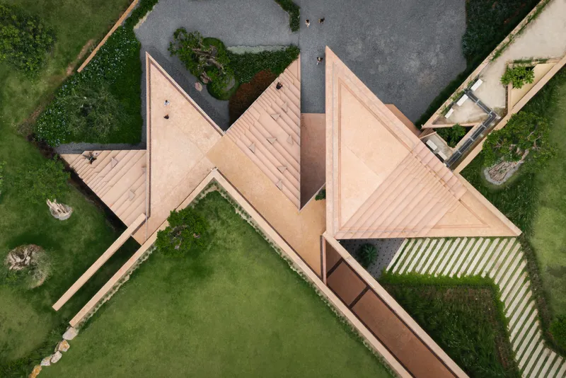 Aerial view of the star-shaped copper roof planes arranged around a central courtyard with gravel paving