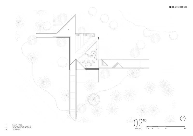 Floor plan drawing showing a rectangular volume with terrace and seating areas surrounded by trees