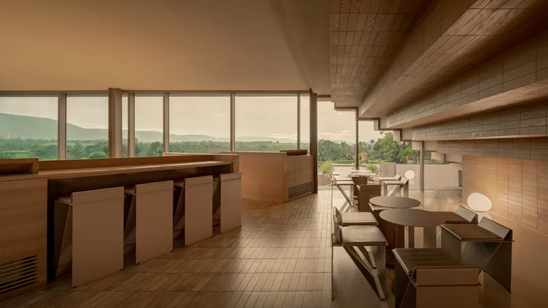 Upper-level seating area with full-height windows overlooking a distant mountain landscape