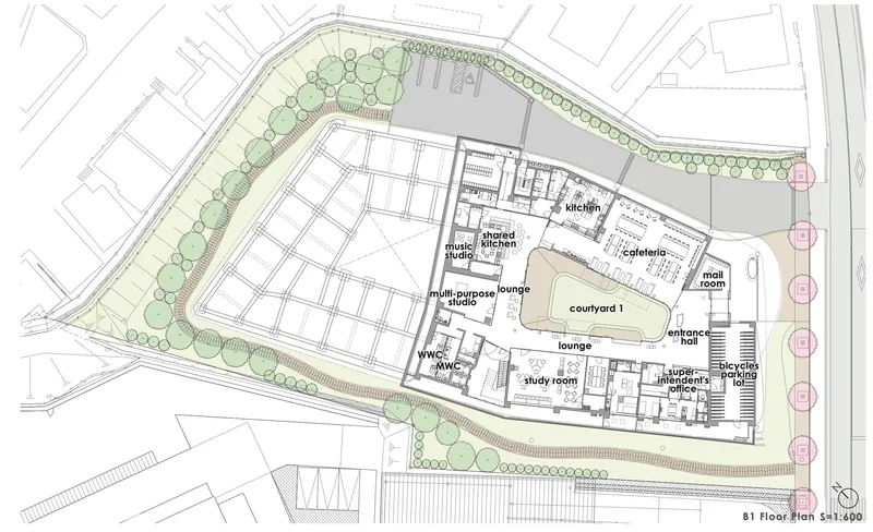 Site plan drawing showing the building footprint with labeled interior spaces and perimeter landscaping