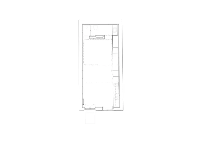 Ground floor plan drawing of a narrow rectangular unit with kitchen and stair