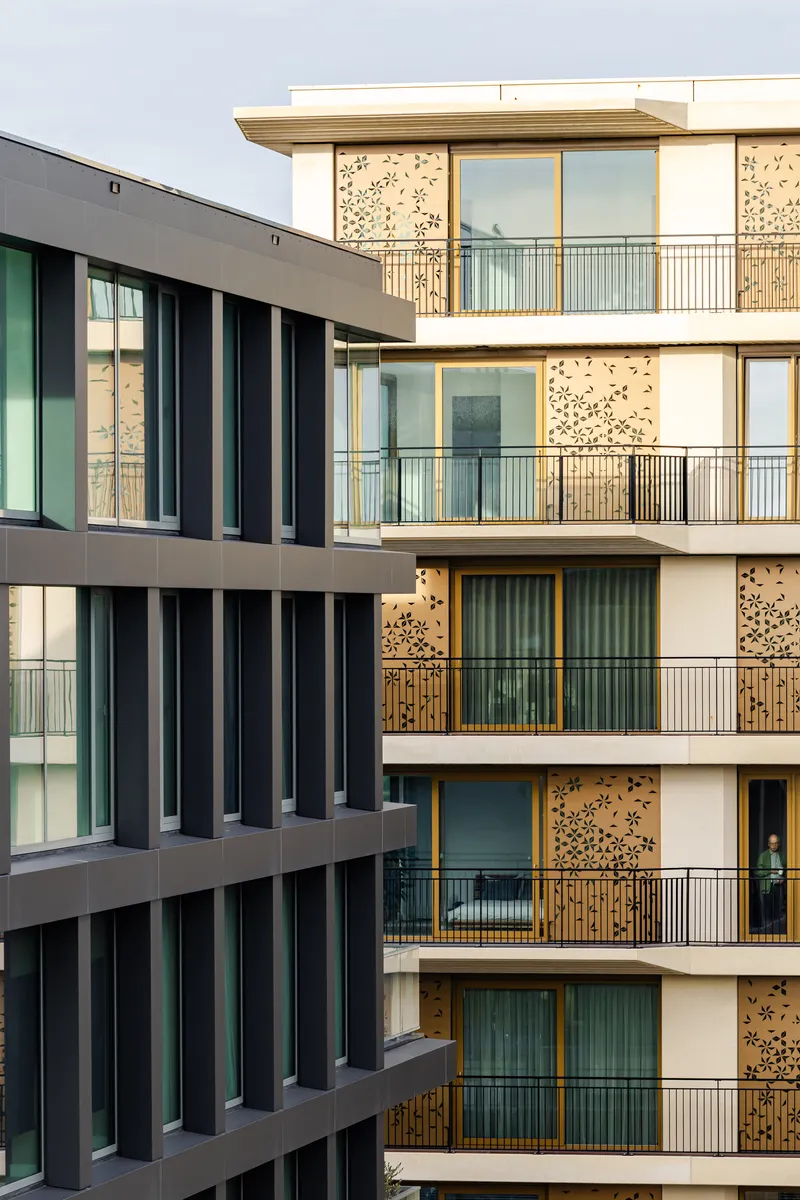 Two contrasting facades showing dark vertical fins against perforated timber panels with stacked balconies