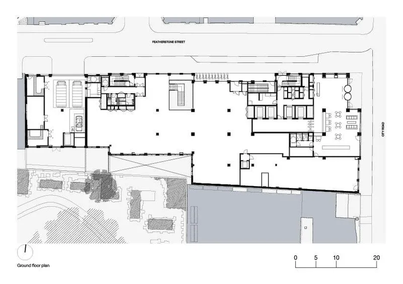 Ground floor plan drawing showing linear massing with clustered service cores and adjacent street context