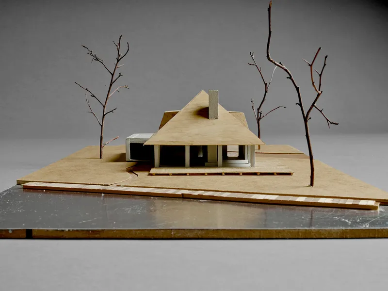 Physical model view of the pitched roof volume with central chimney and bare branches