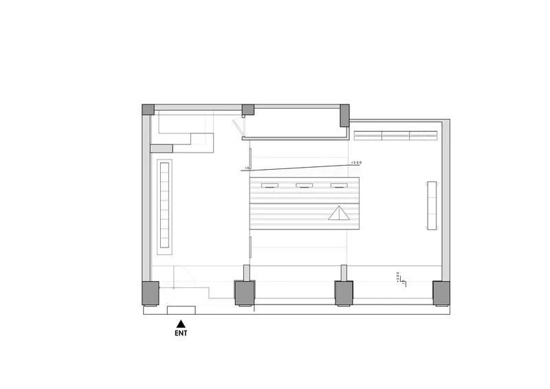 Floor plan drawing showing a rectangular retail space with central service counter and street entrance