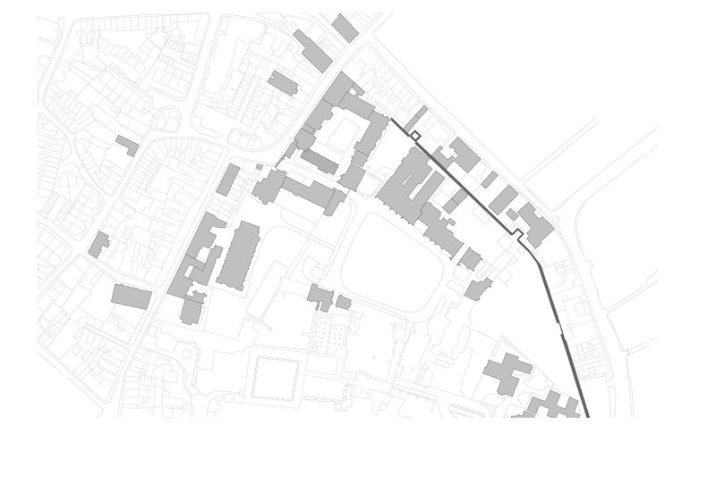 Site plan drawing showing a cluster of buildings within an urban block with surrounding street grid