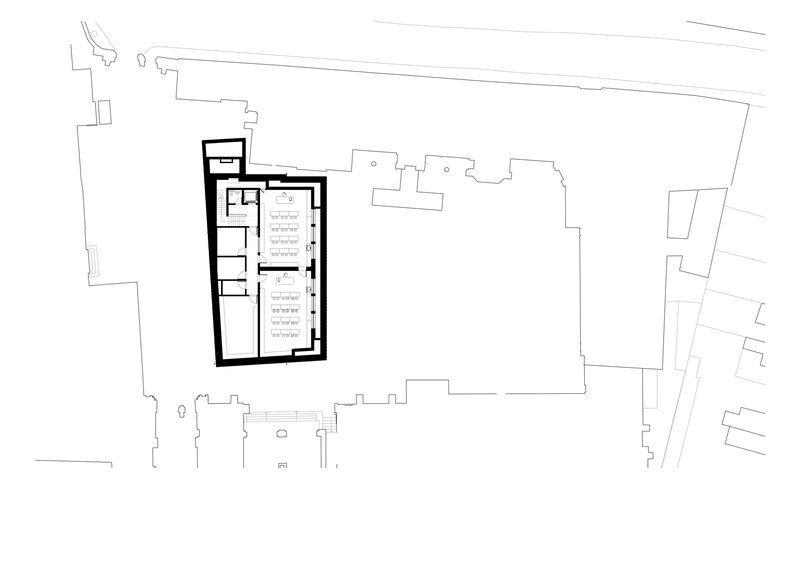 Floor plan drawing of a rectangular structure with thick walls and rows of seating facing east