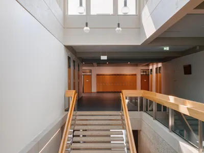 Burckhardt Lifts a Timber Story onto a 1969 Brutalist School in Geneva Without Breaking the Spell