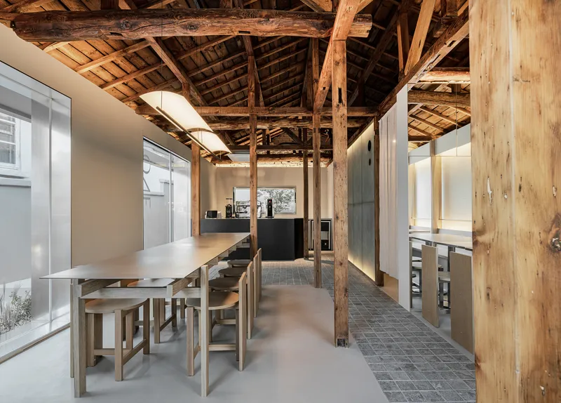 Long view through dining area showing timber columns beneath the original timber roof structure