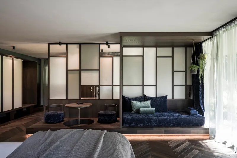 Raised platform seating area with integrated strip lighting beneath the dark timber base