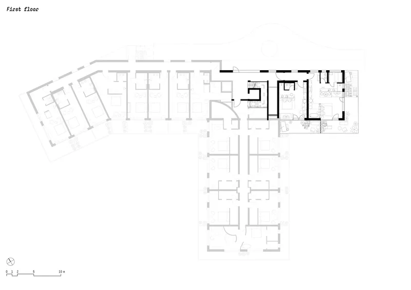 First floor plan depicting angled wings of residential units and central circulation zones