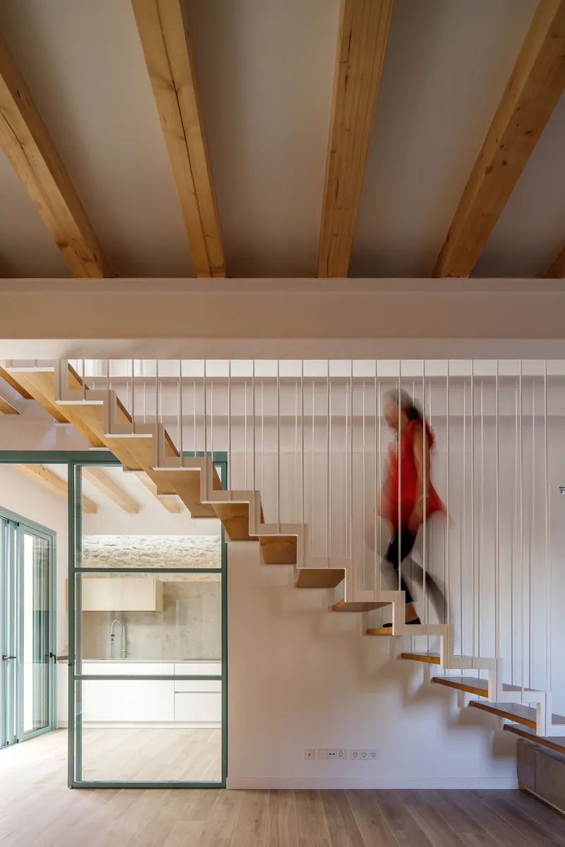 Floating timber staircase with a figure in motion captured as a blur ascending the steps