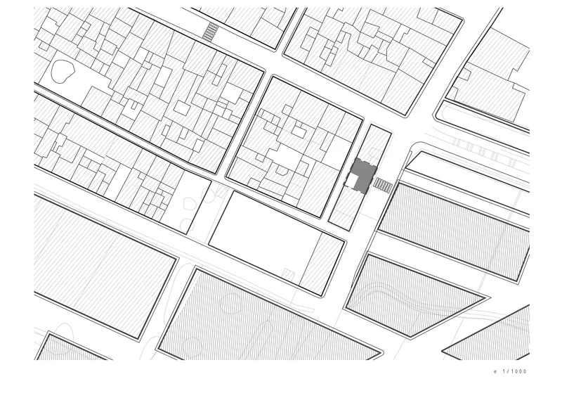 Site plan drawing showing the building footprint highlighted among surrounding urban blocks and streets