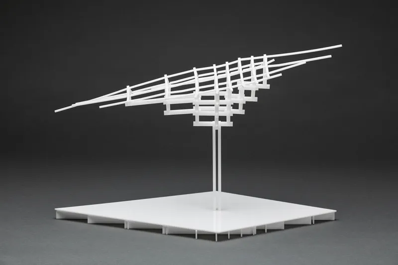 Physical model of a tilted gridded roof canopy supported by twin columns on a flat platform base