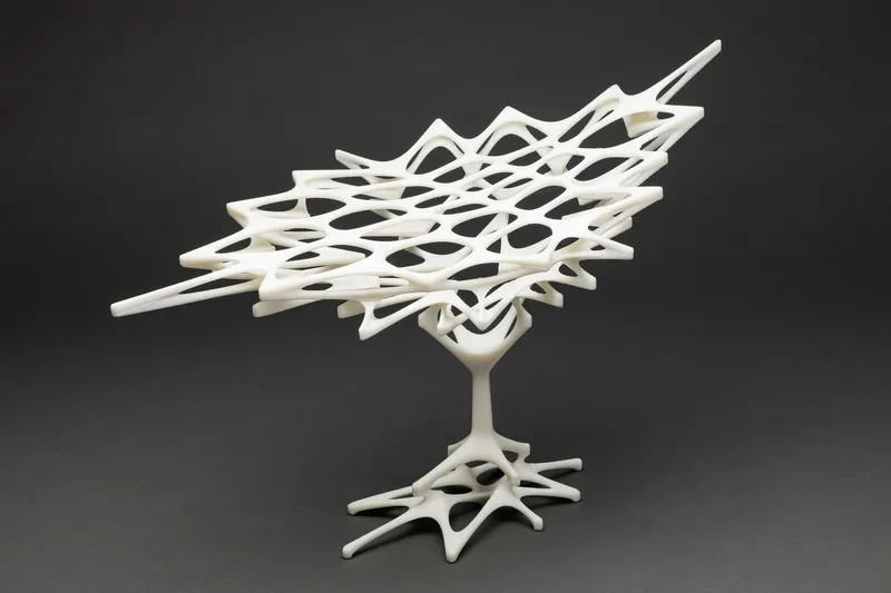 White physical model showing a branching organic roof structure rising from a single tree-like base